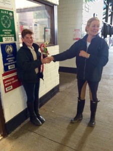 Winner of the Midi Show-Jumping competion Ciaran Darcy receives his prize from Assistant Instructor Eyleen Nugent